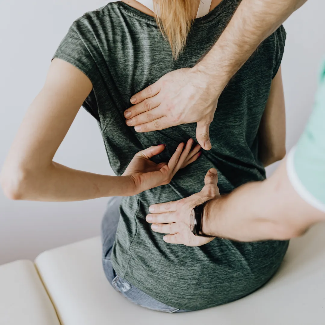 Woman holding her lower back in pain